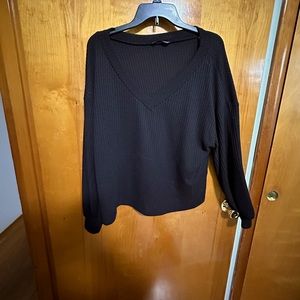 Black v-neck sweater. Shorter fit, almost cropped